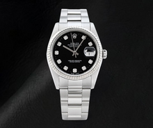 Afbeelding in Gallery-weergave laden, Rolex Datejust horloge met zwarte wijzerplaat en diamanten, en roestvrijstalen Oyster-armband.